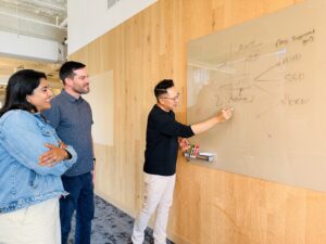 Dan Kim writing on whiteboard at Airwallex